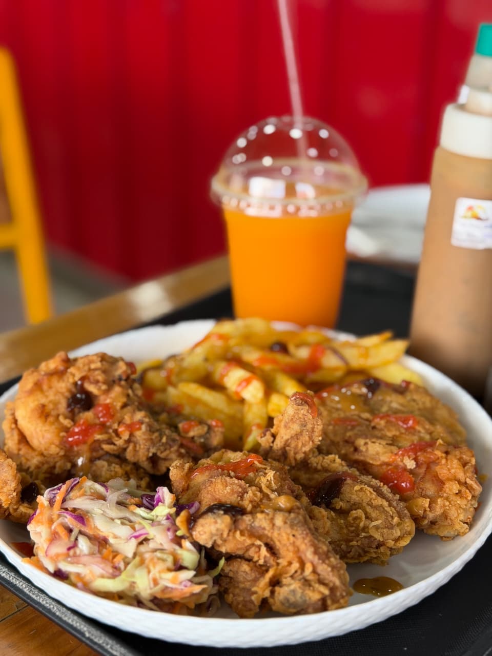 A plate of ChickenRun's crispy fried chicken, chips, and coleslaw